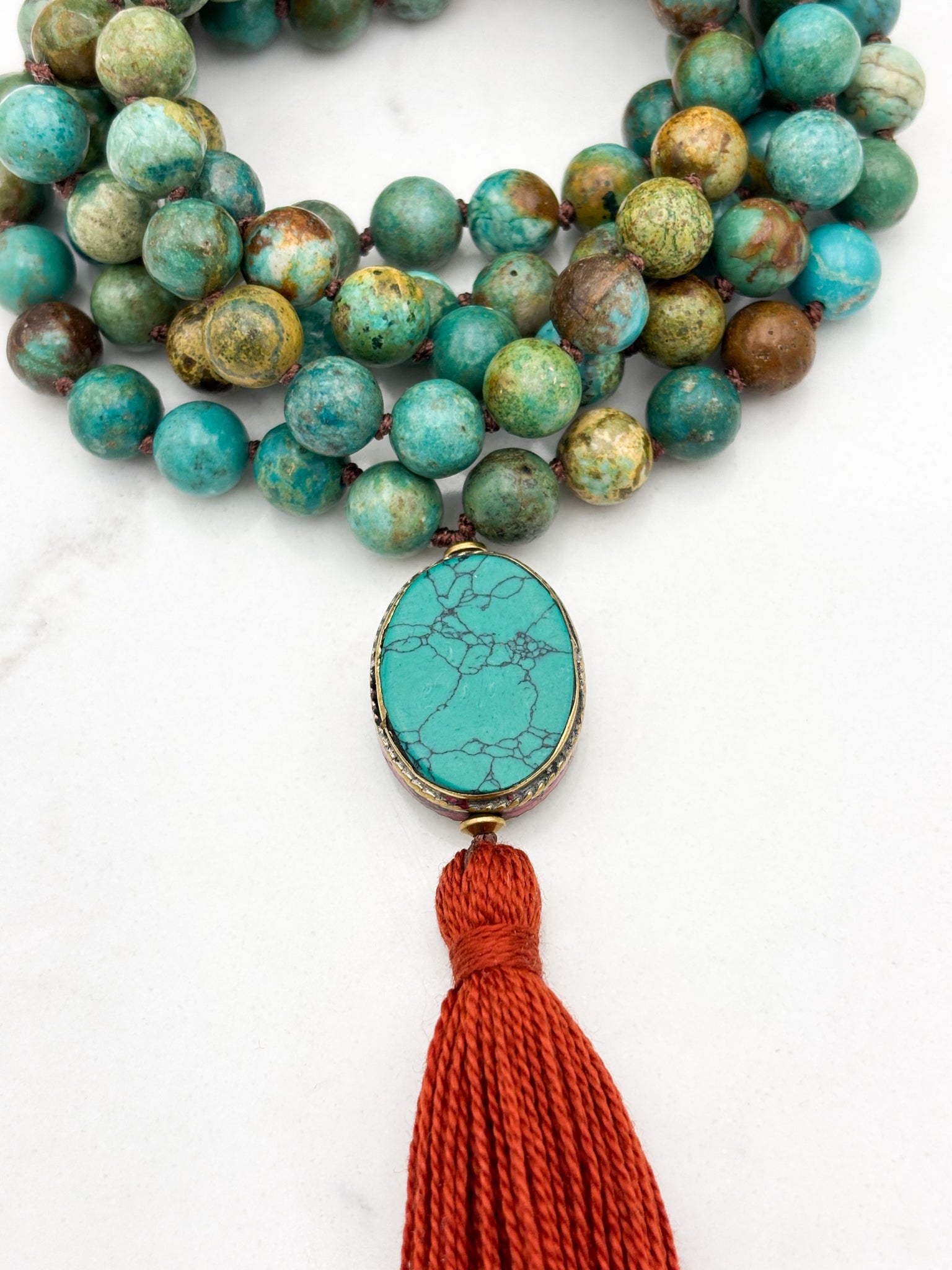 turquoise gemstone mala with turquoise guru bead and rust tassel | radiant malas | handmade in boulder, colorado																		