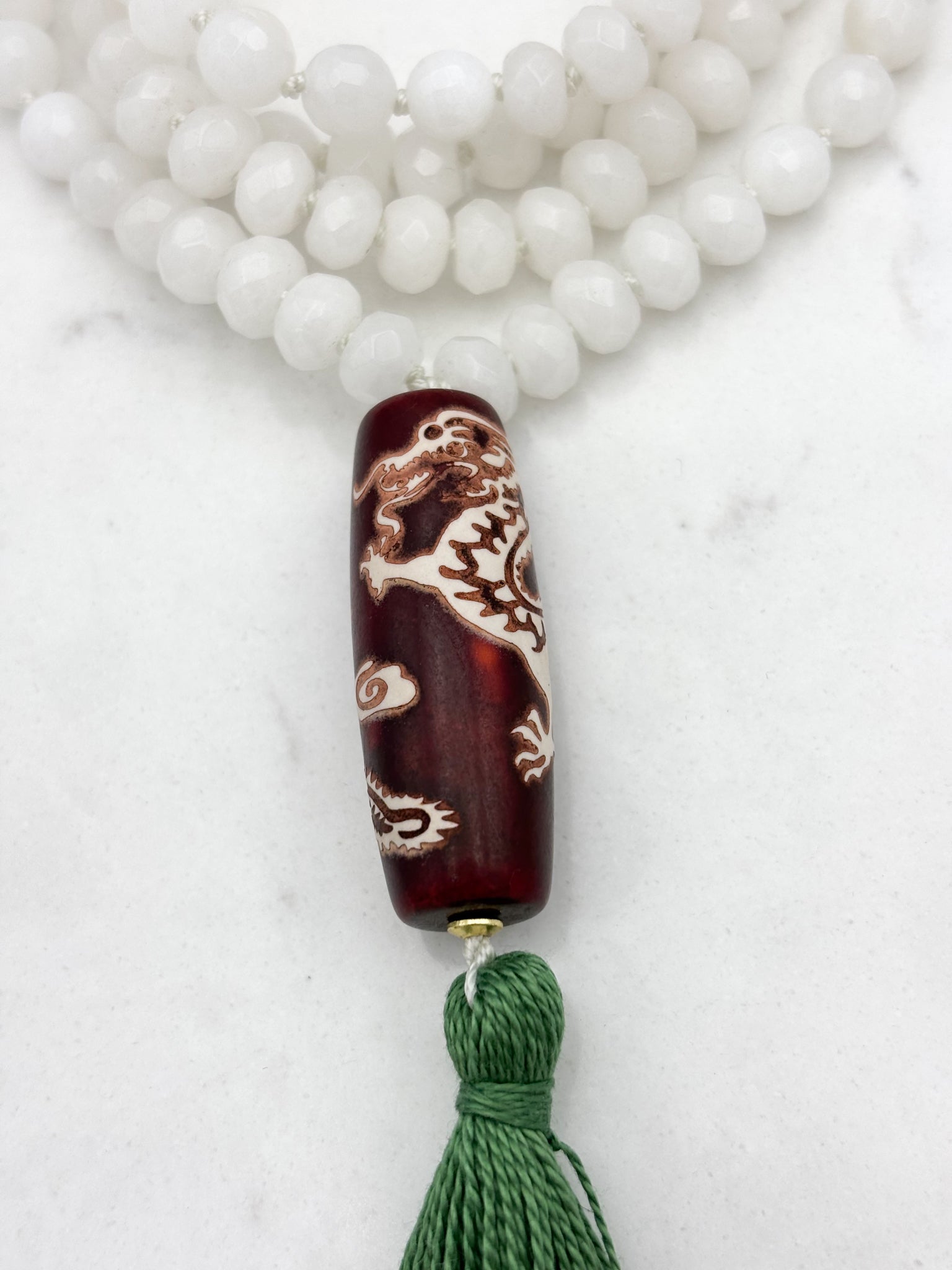 white jade gemstone mala necklace with wood/dragon guru bead and green tassel | radiant malas | handmade in boulder, colorado