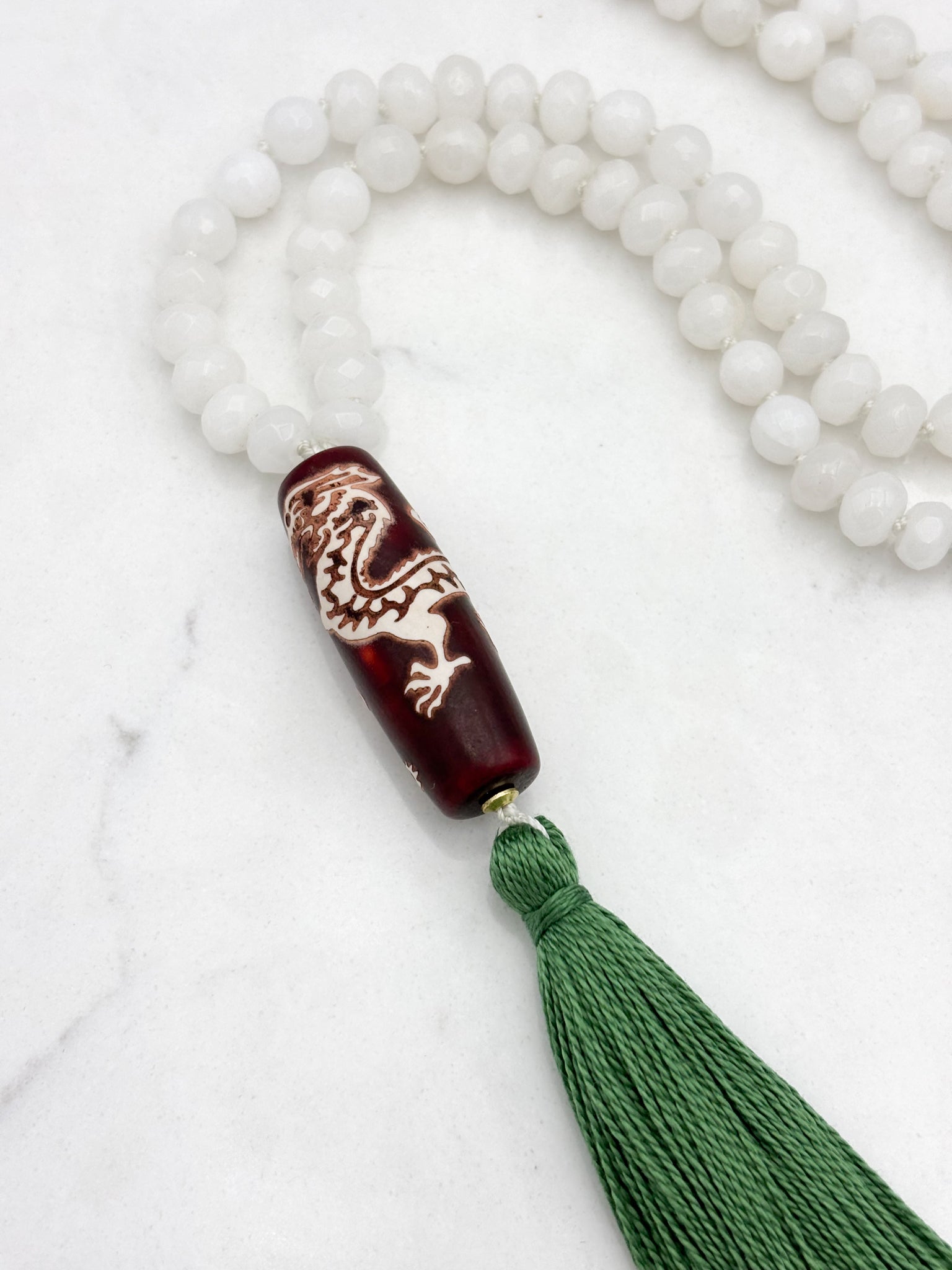white jade gemstone mala necklace with wood/dragon guru bead and green tassel | radiant malas | handmade in boulder, colorado