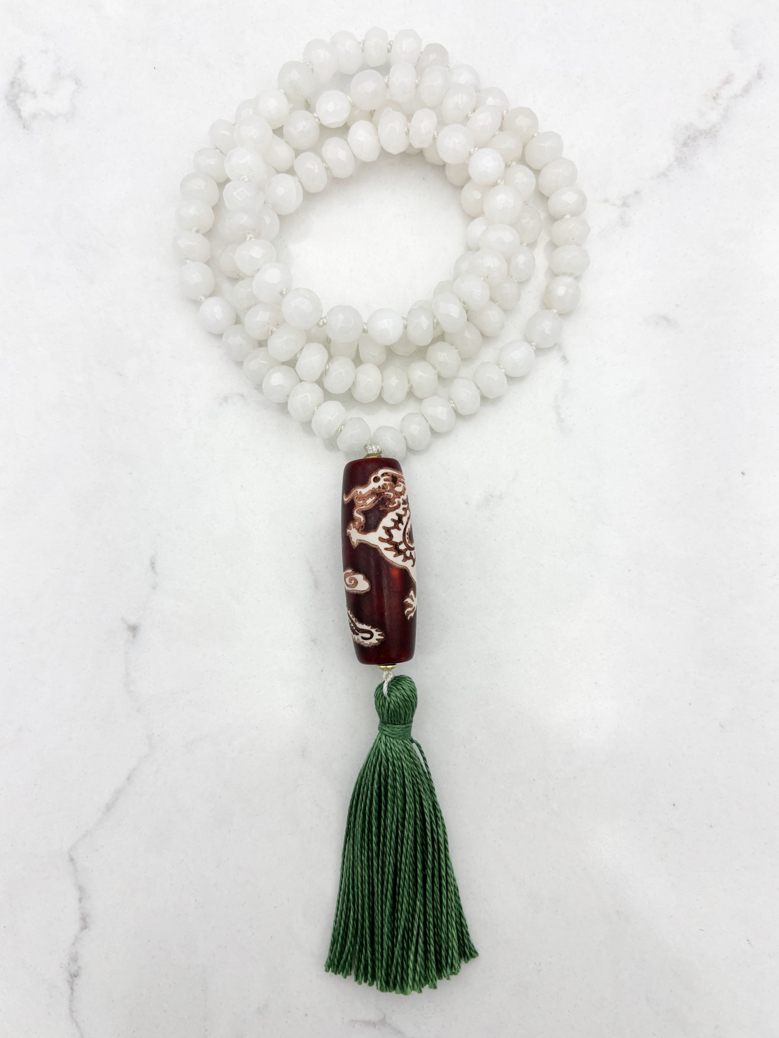 white jade gemstone mala necklace with wood/dragon guru bead and green tassel | radiant malas | handmade in boulder, colorado