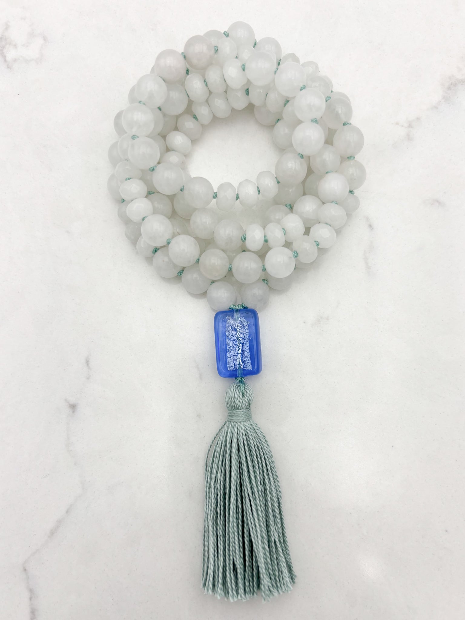 white jade gemstone mala necklace with blue lampwork glass guru bead and seafoam green tassel | radiant malas | handmade in boulder, colorado