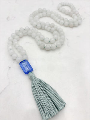 white jade gemstone mala necklace with blue lampwork glass guru bead and seafoam green tassel | radiant malas | handmade in boulder, colorado
