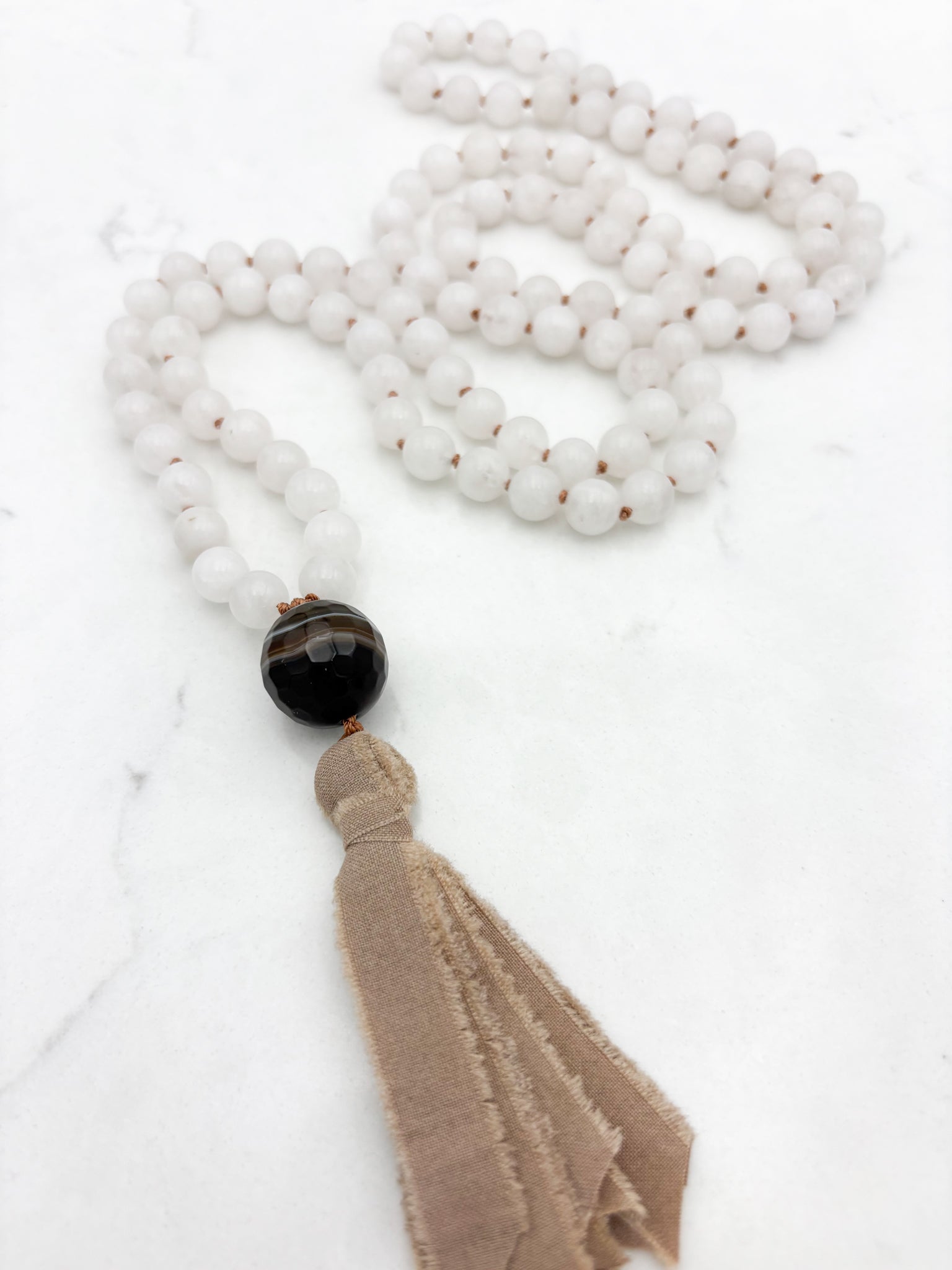 white jade gemstone mala necklace with sardonyx guru bead and silk tassel | radiant malas | handmade in boulder, colorado